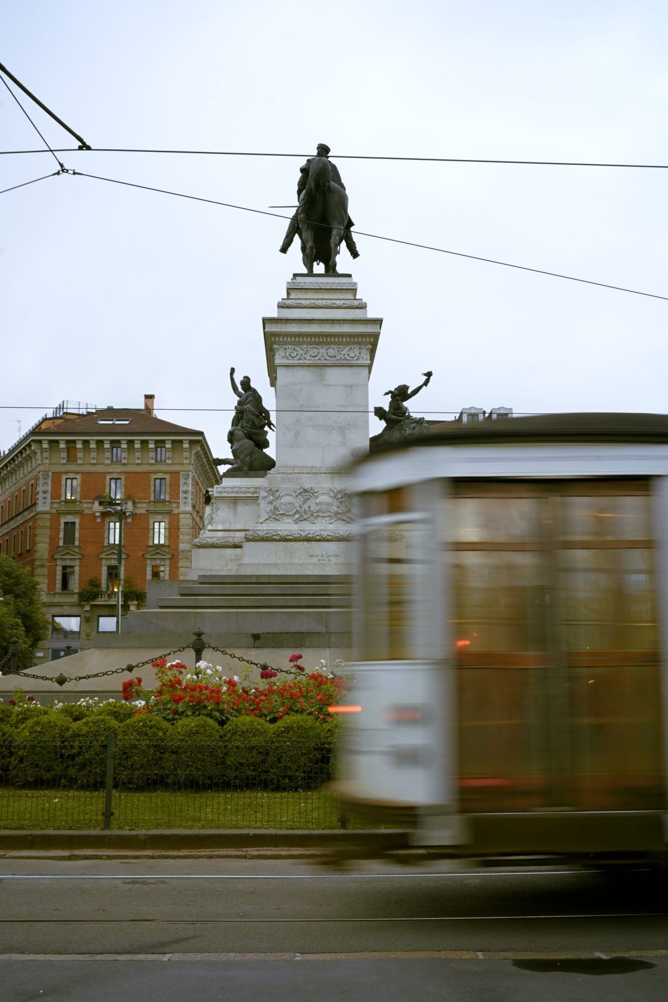A tilted, long-exposure view of a Milan street — movement resolved into stillness.