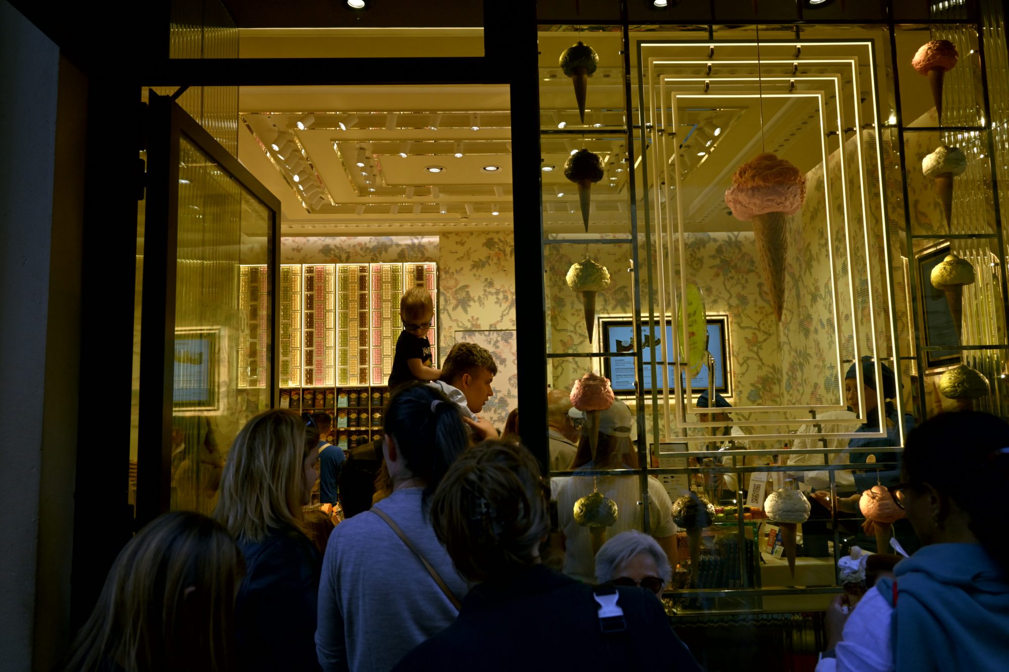 Inside the Galleria, figures under golden light.