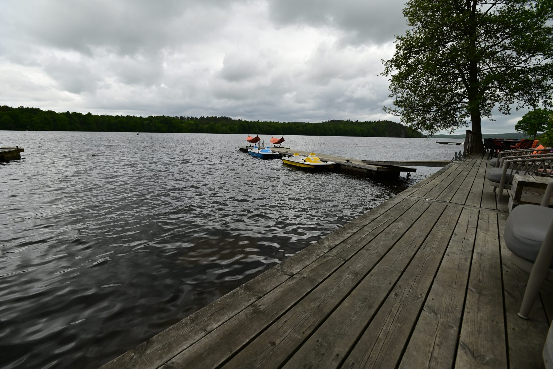 A jetty and boats on a grey afternoon.