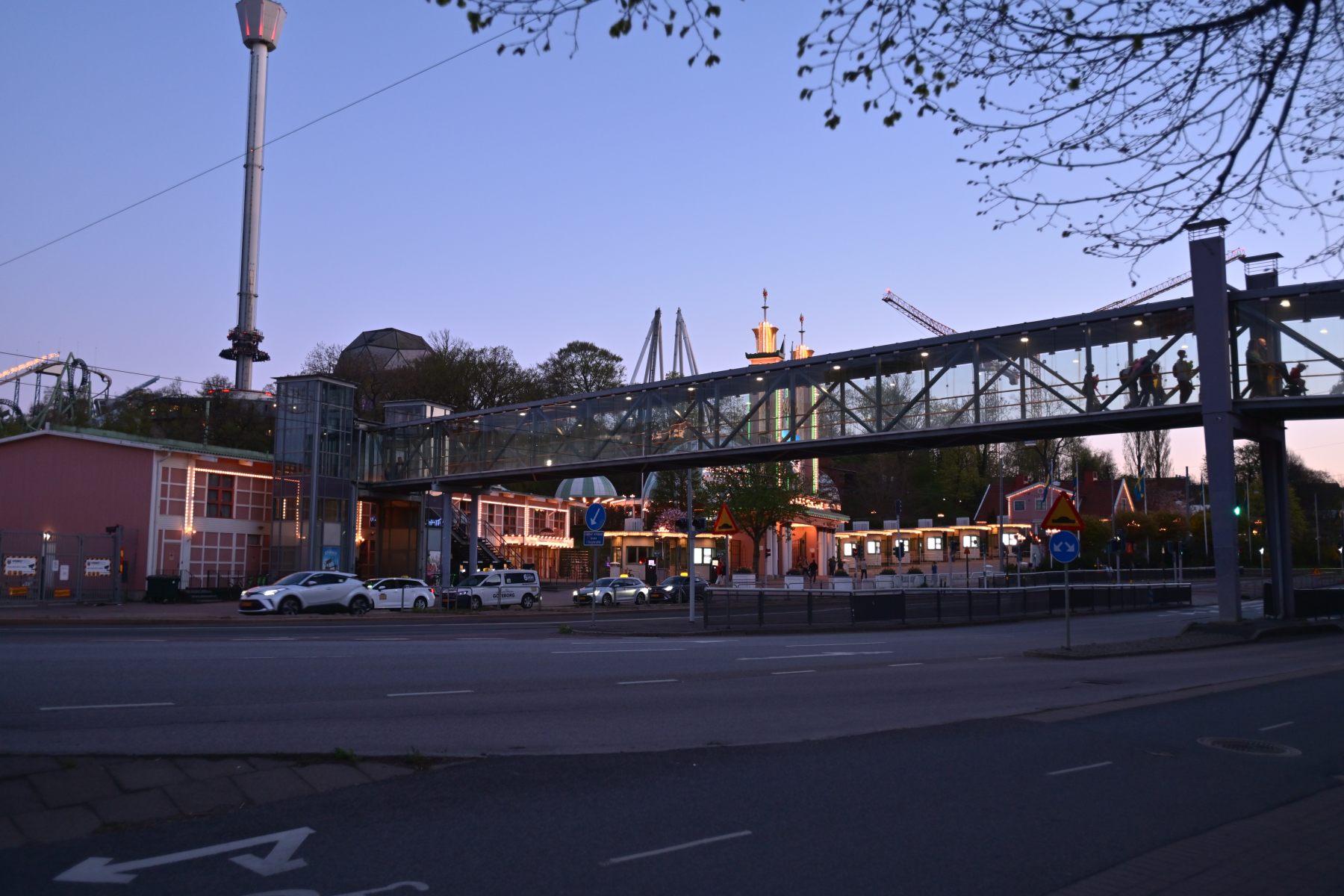 A road at dusk with a distant crane.